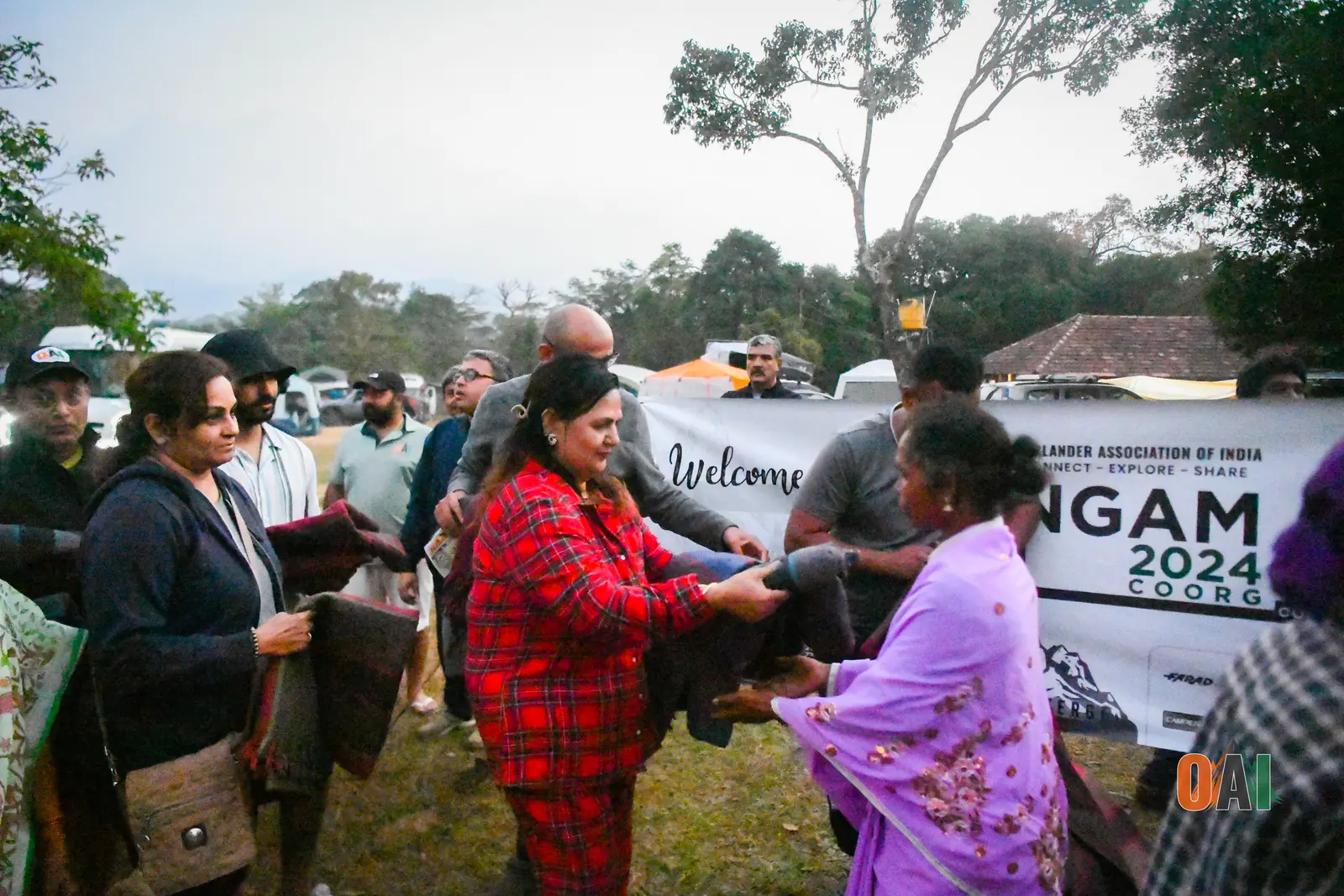 OAI members handing out blankets at a community welcome event