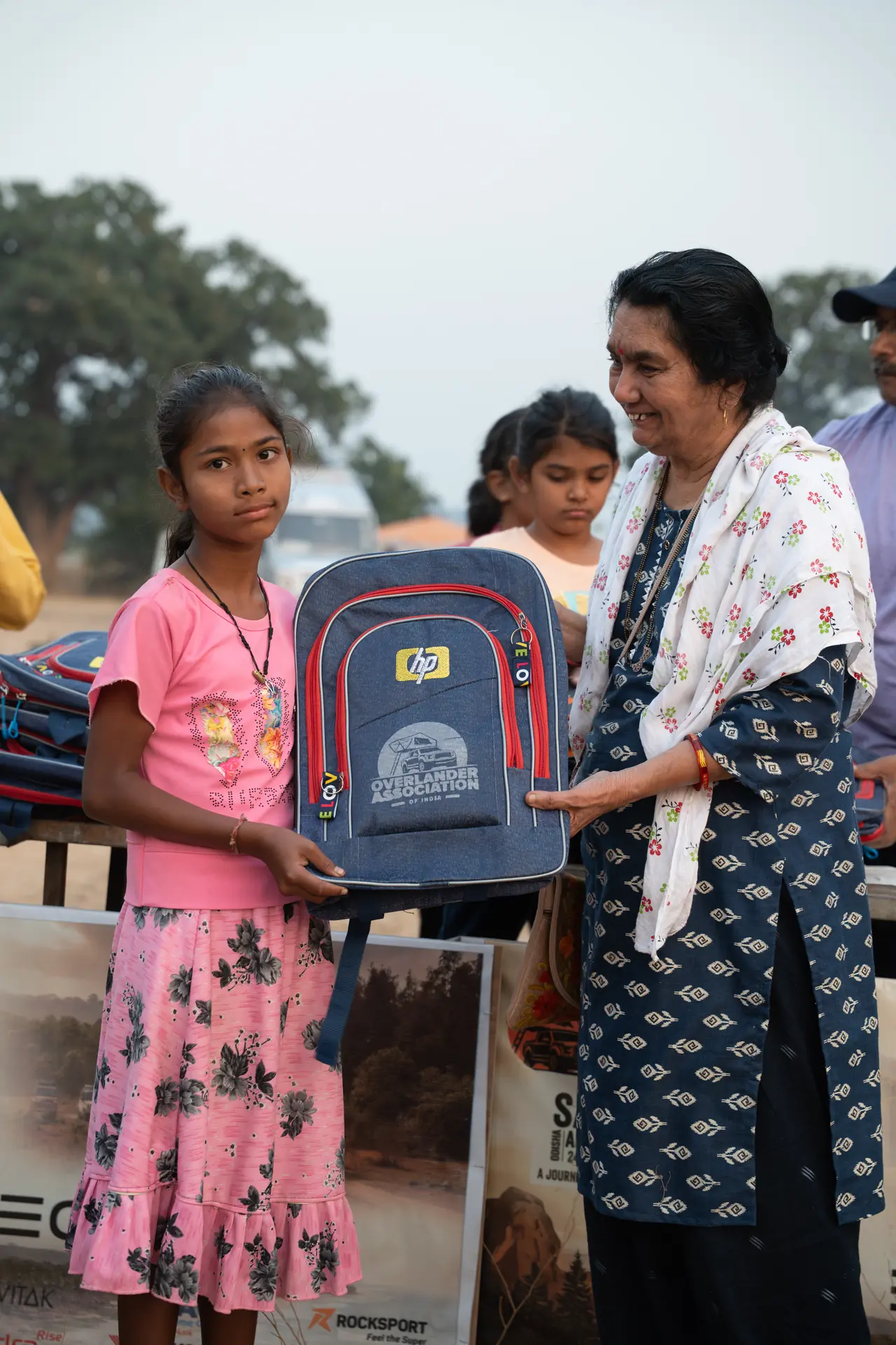 A child receiving an OAI-branded school backpack