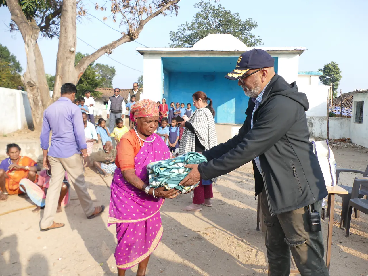 OAI members distributing blankets to villagers near Kanha Kisli, Mocha Village