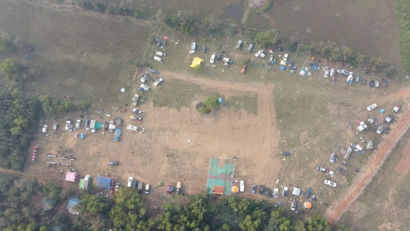 Aerial overview of the full Sangam 2025 campground with vehicles parked around the perimeter